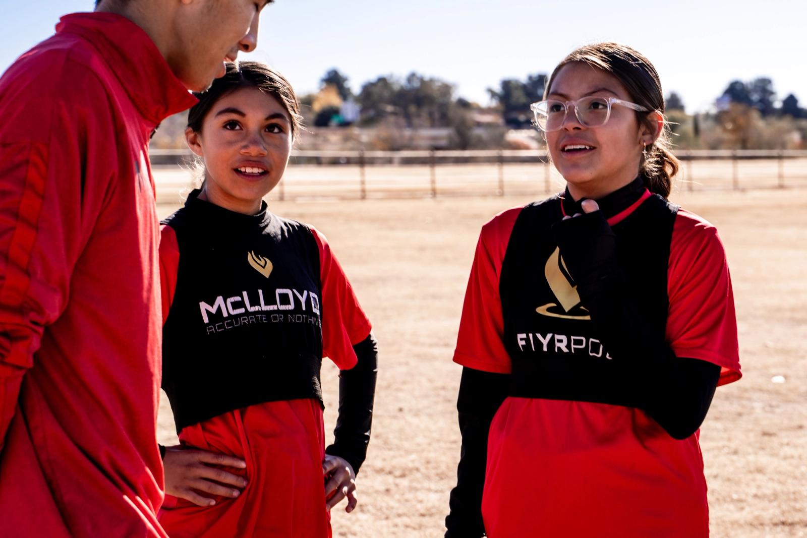 Two players talking on the sideline