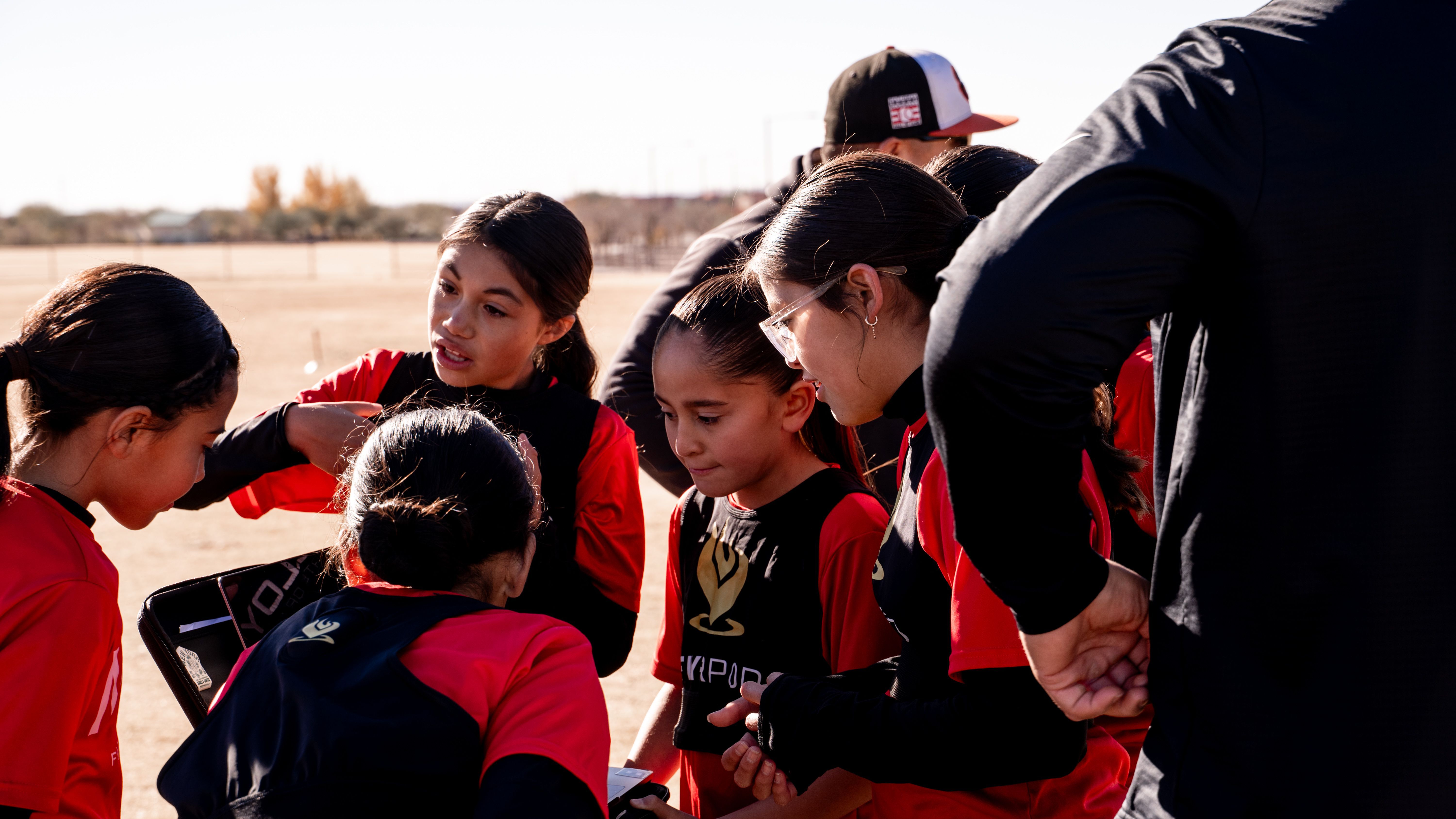 Girls U14 huddle, hands in before kickoff