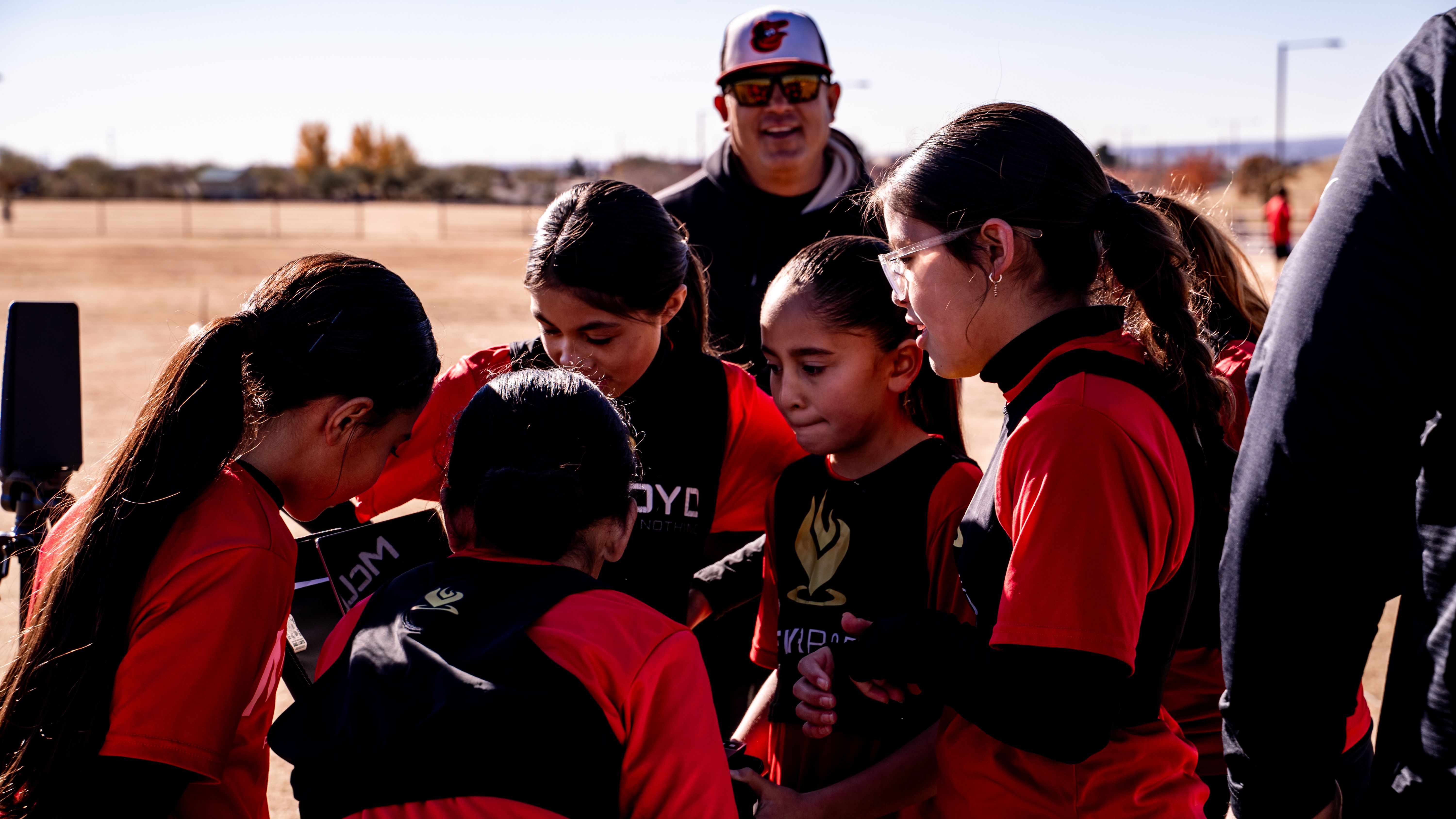 Coach talking with Girls U14 players in a huddle