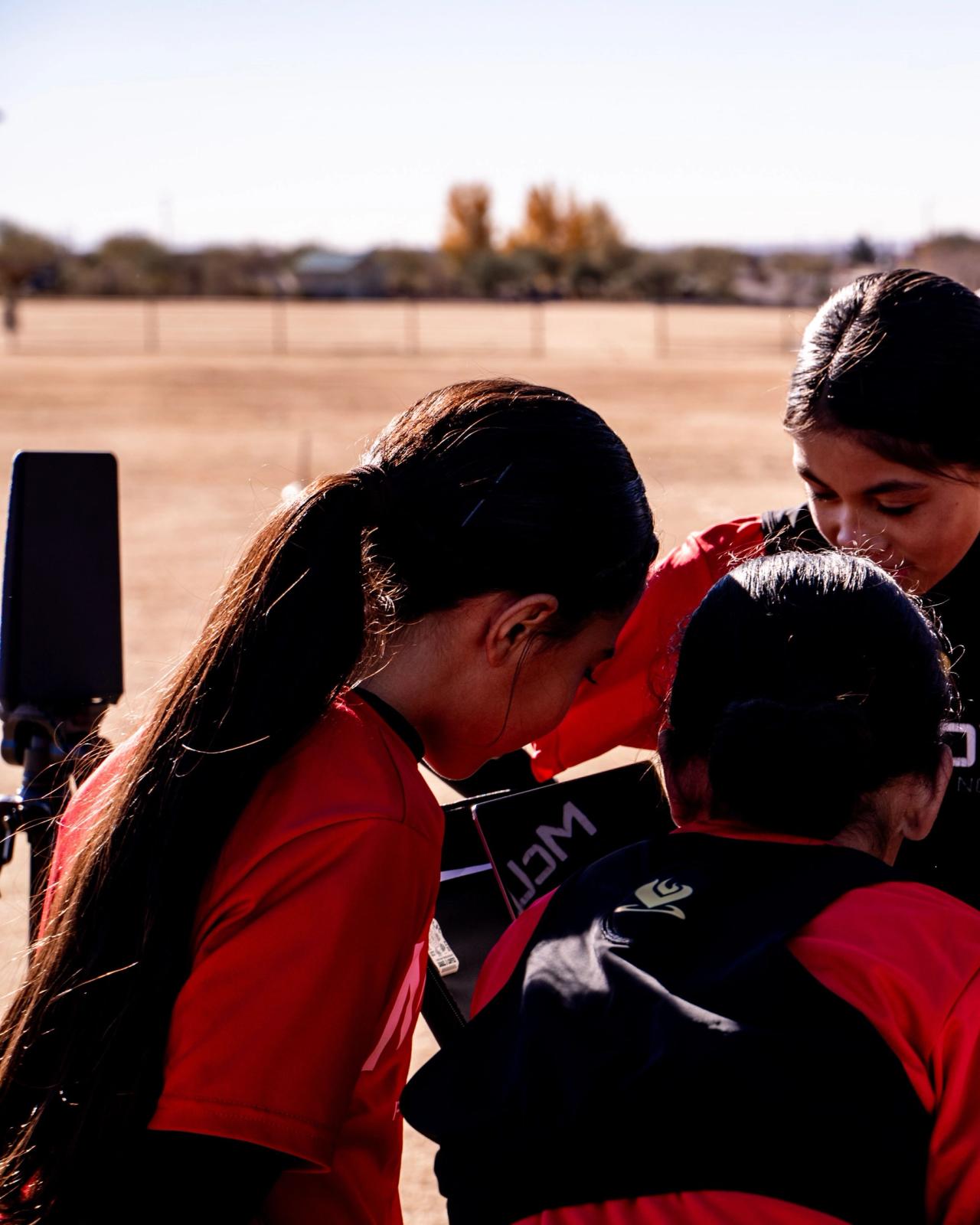 Coach talking with Girls U14 players in a huddle