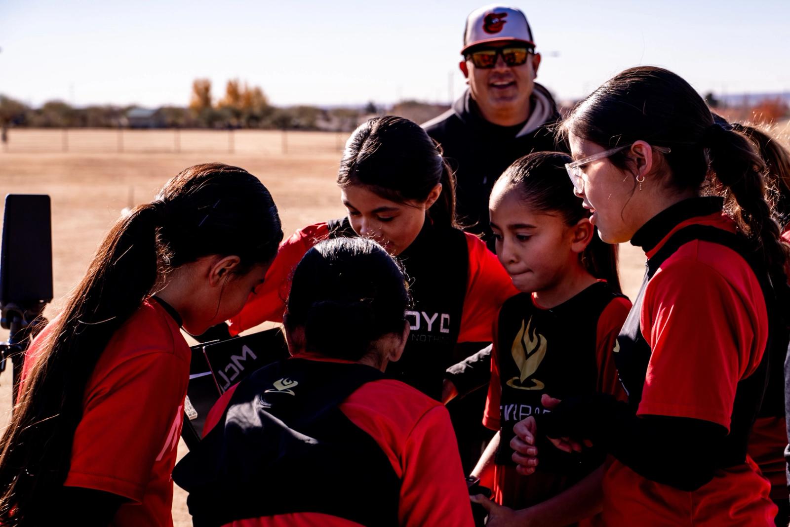 Coach talking with Girls U14 players in a huddle