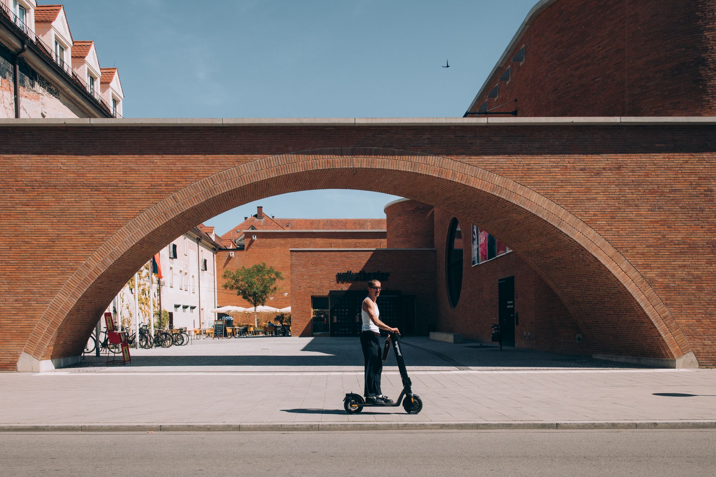 Man riding Augment e-scooter near a harbour