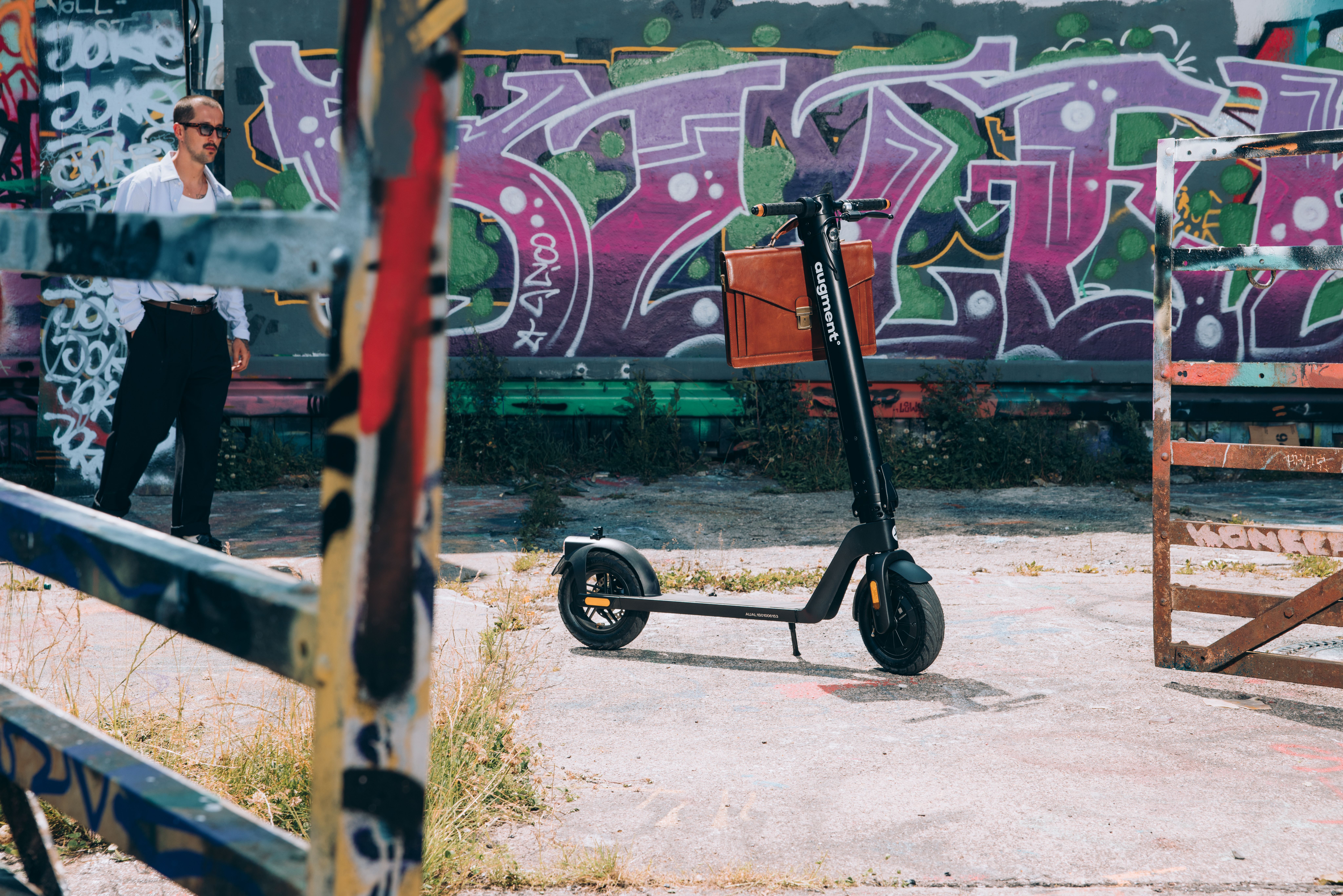 Augment e-scooter side view in front of wooden wall