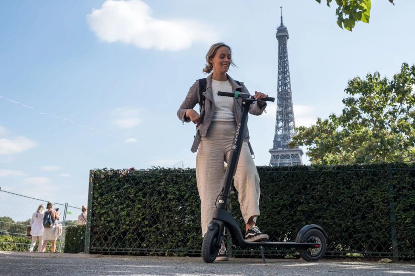 Woman with e-scooter in Paris