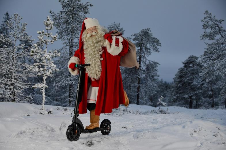 Le Père Noël chevauchant l'e-scooter Augment sur la neige