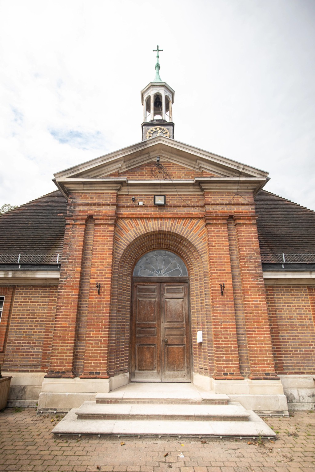 Belmont, Mill Hill Prep front of chapel, with steps leading up to a large wooden door.