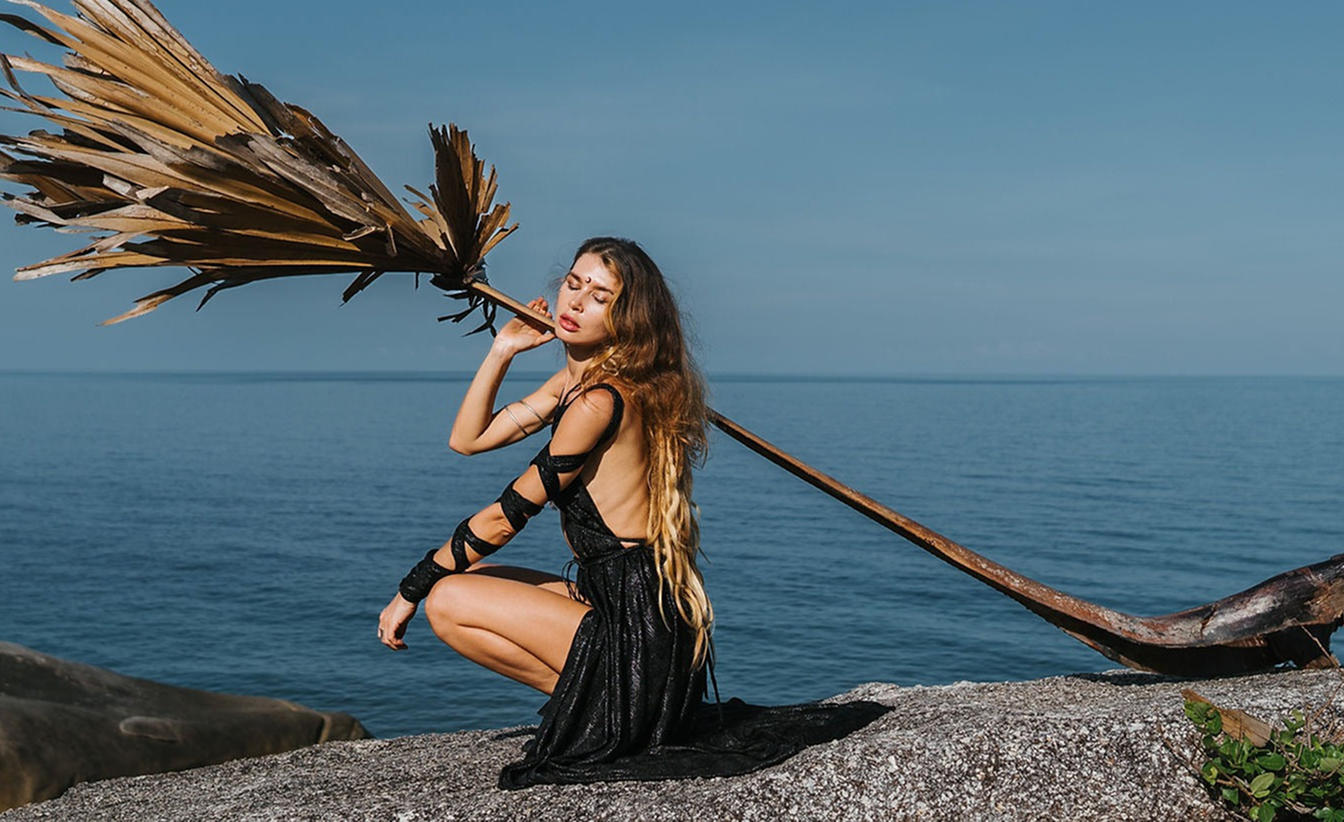Woman on the beach with a broom