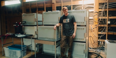 Mark Smith, Co-founder of Carbon Country, standing alongside their immersion mining setup in their barn in Maryland.
