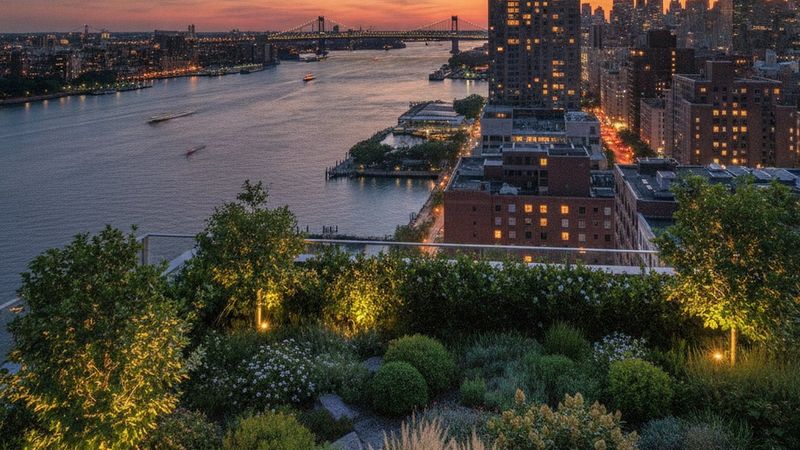 Editorial photograph of the Hudson River waterfront at dusk seen from a West Village terrace, planted rooftop in the for
