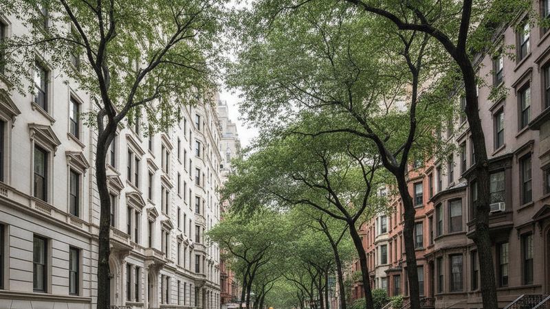 Editorial photograph of an Upper East Side residential side street with pre-war limestone apartment houses and brownston