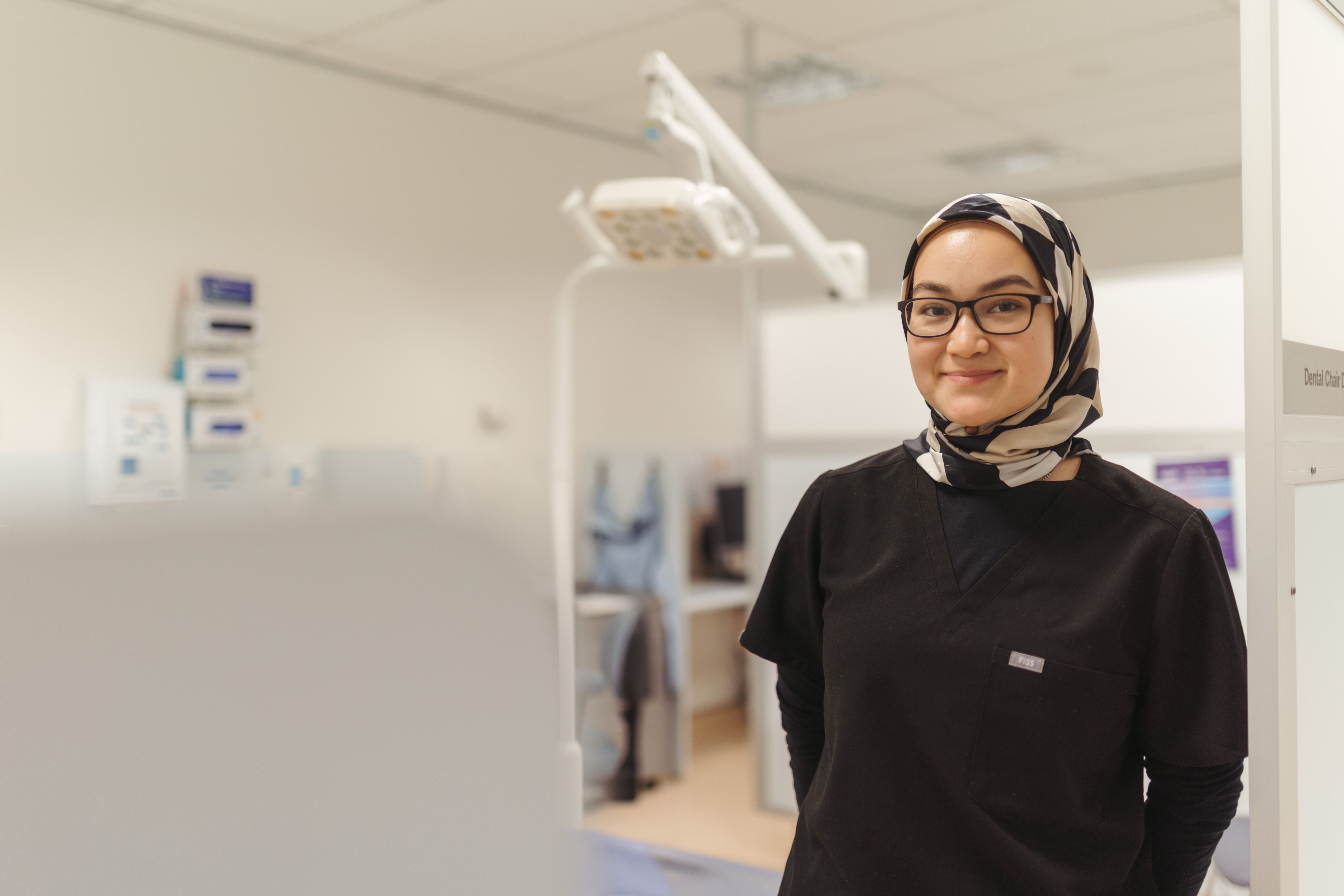 Friendly oral health therapist smiling at the camera.