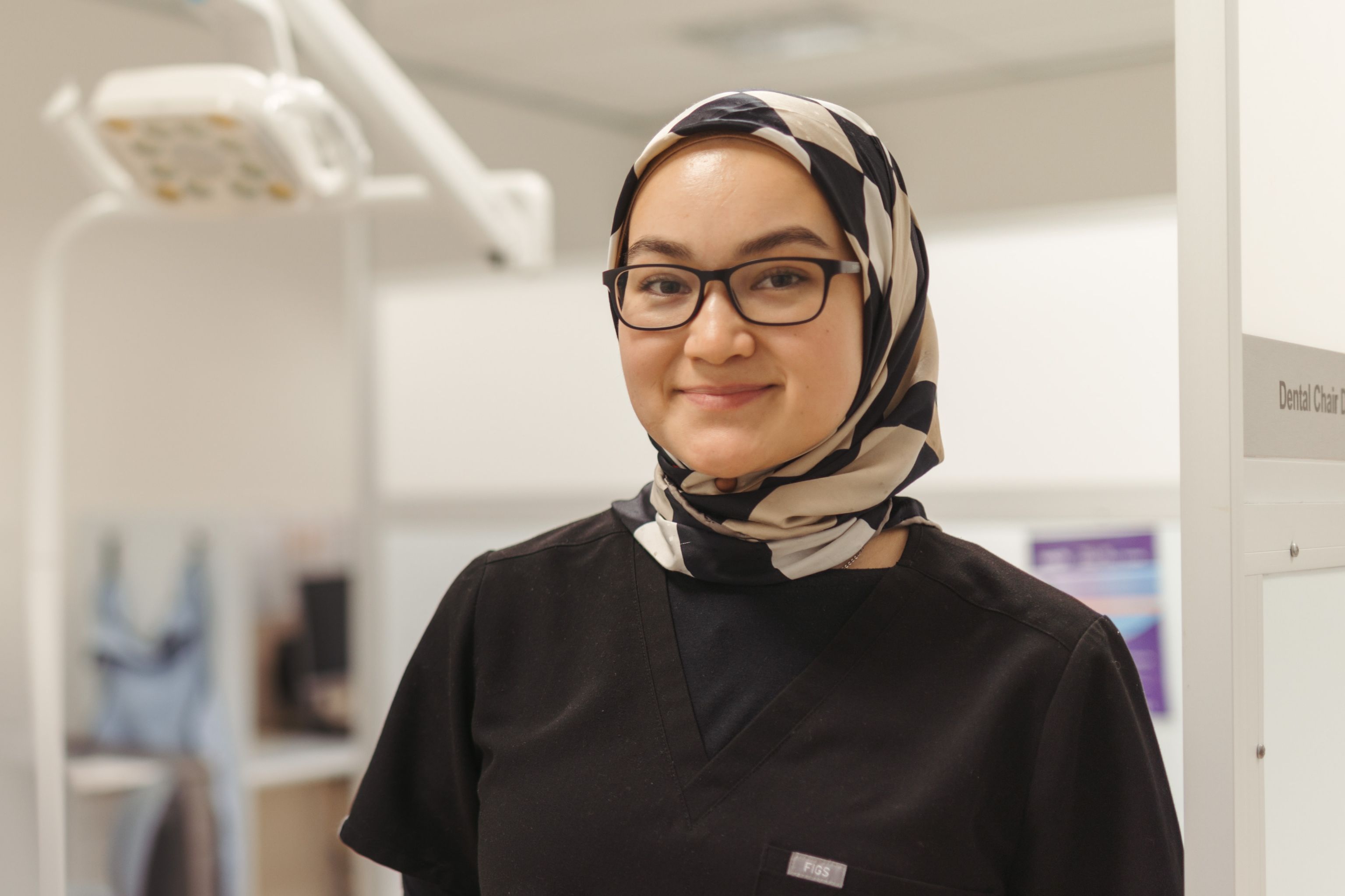 Friendly oral health therapist smiling at the camera.