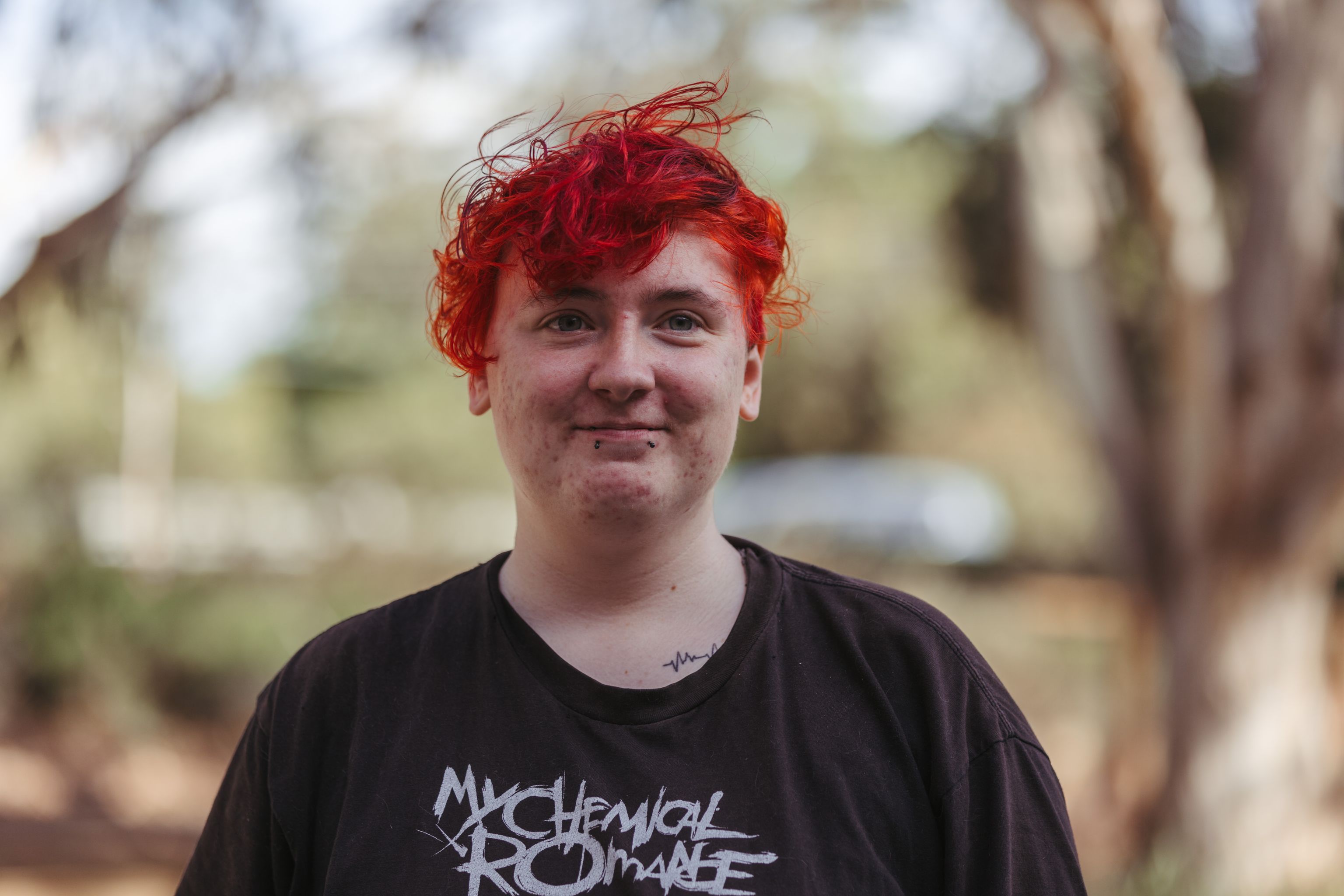 Young person, Nexus, outdoors smiling at the camera.