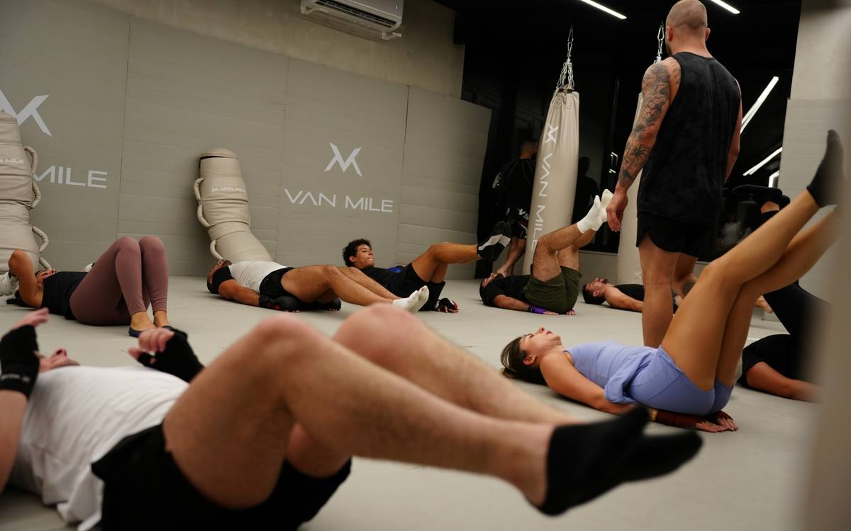 Conditioning class working on the mats with the coach