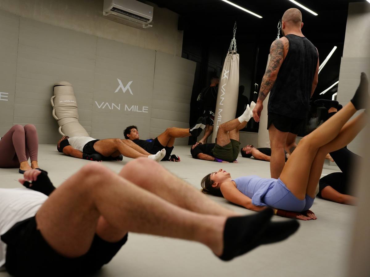 Conditioning class working on the mats with the coach