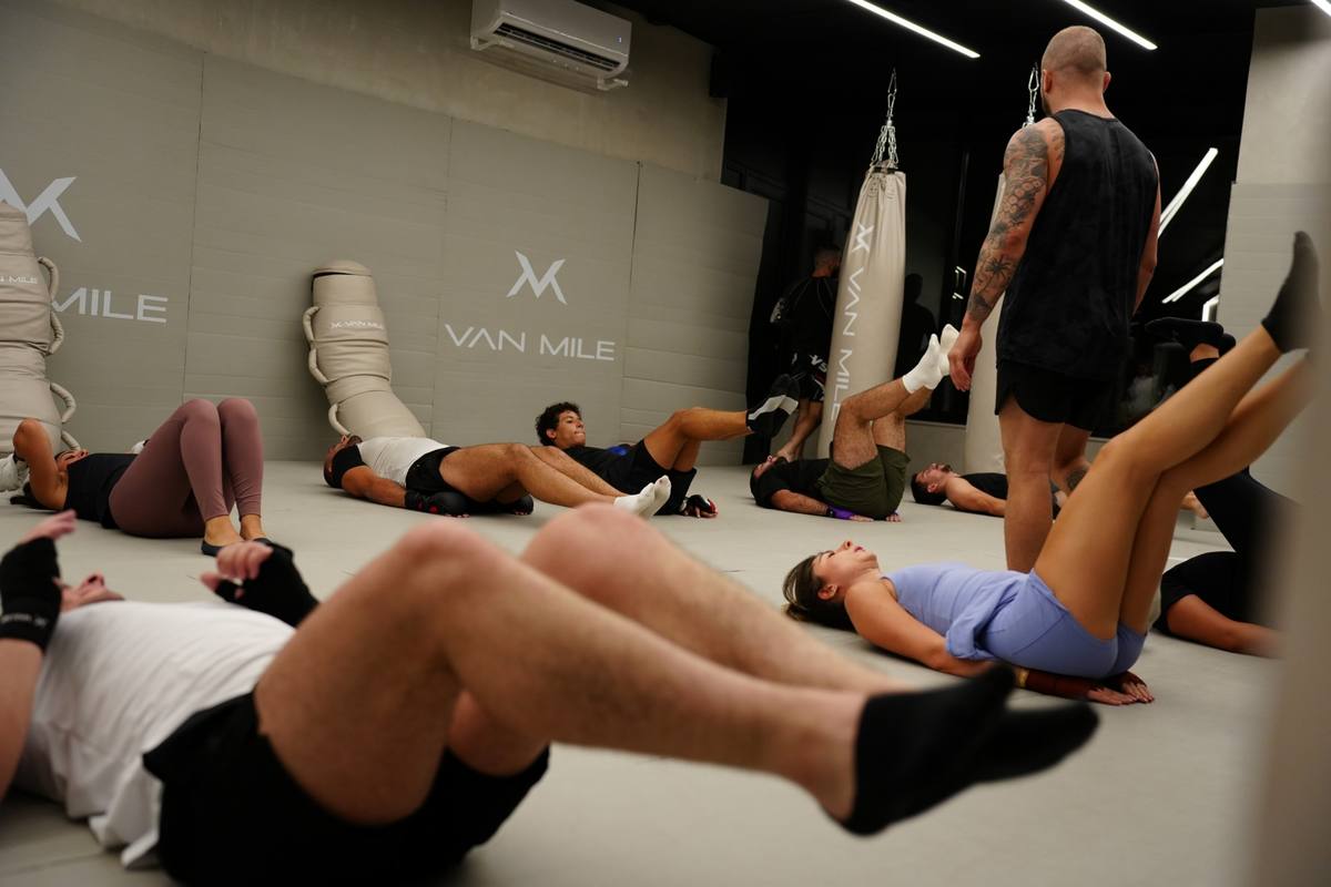 Conditioning class working on the mats with the coach