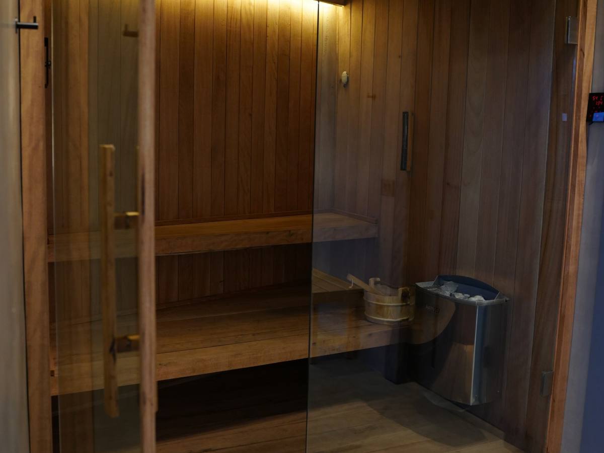 The custom wood sauna behind glass doors