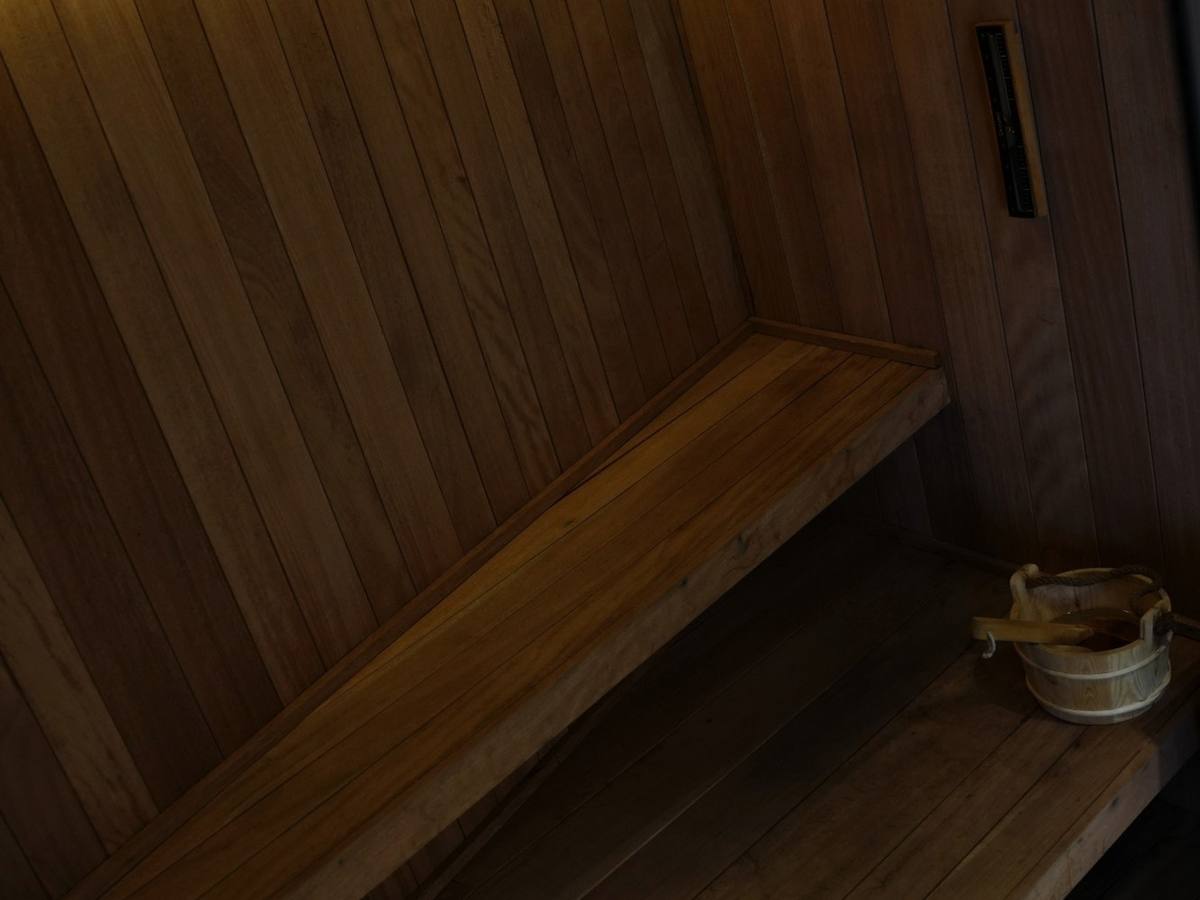 Inside the sauna: warm-lit wood benches