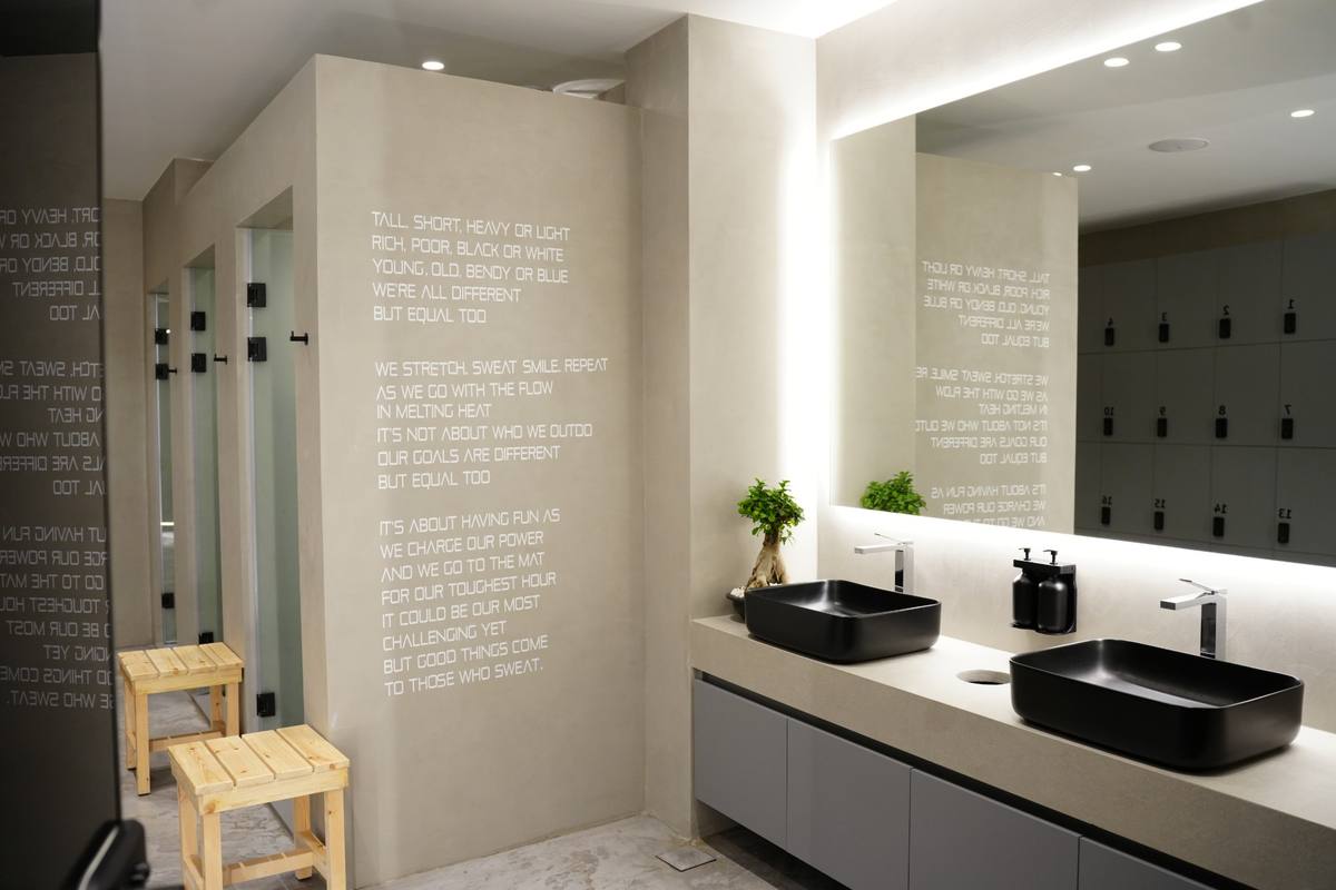 Locker room: showers, double sinks and the manifesto wall