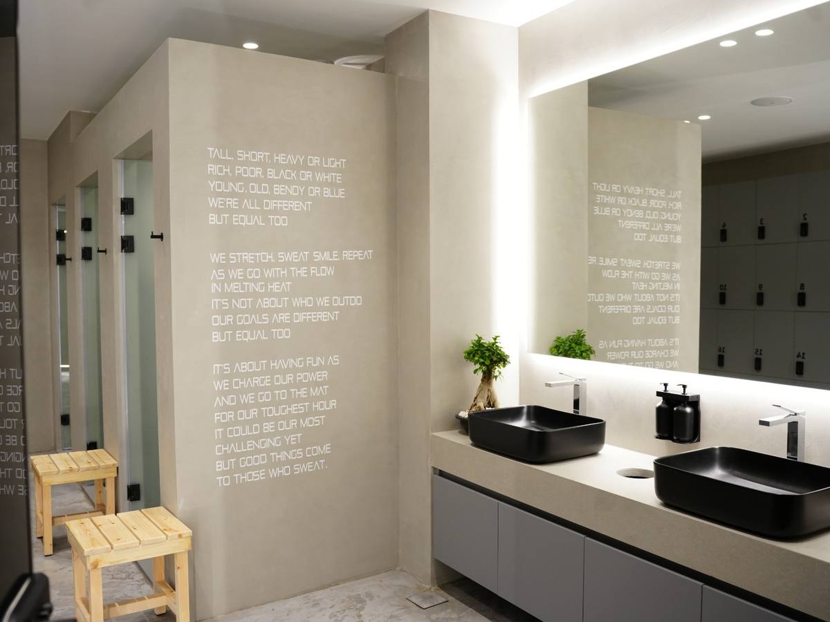 Locker room: showers, double sinks and the manifesto wall
