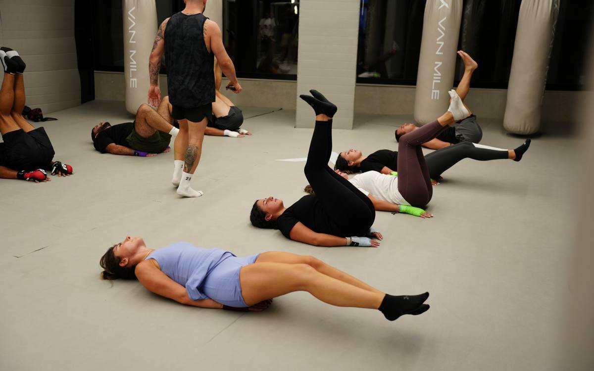 Core work in a conditioning class, hands wrapped