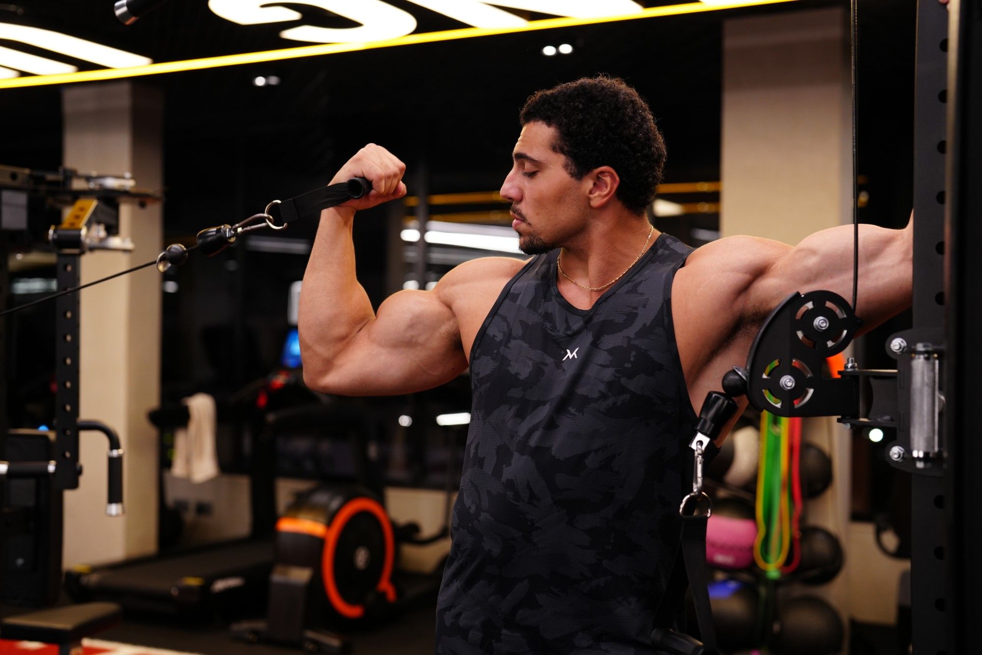 Cable curl on the gym floor, VM tank top