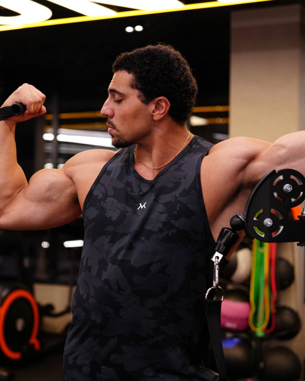 Cable curl on the gym floor, VM tank top