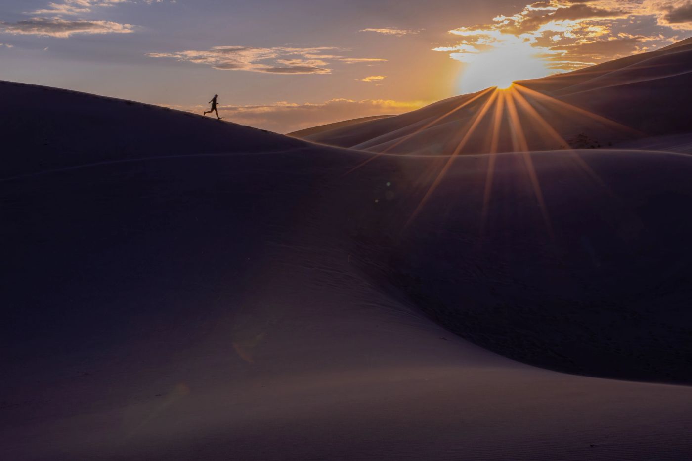 Great Sand Dunes National Park at sunrise with Colorado mountains in the background.