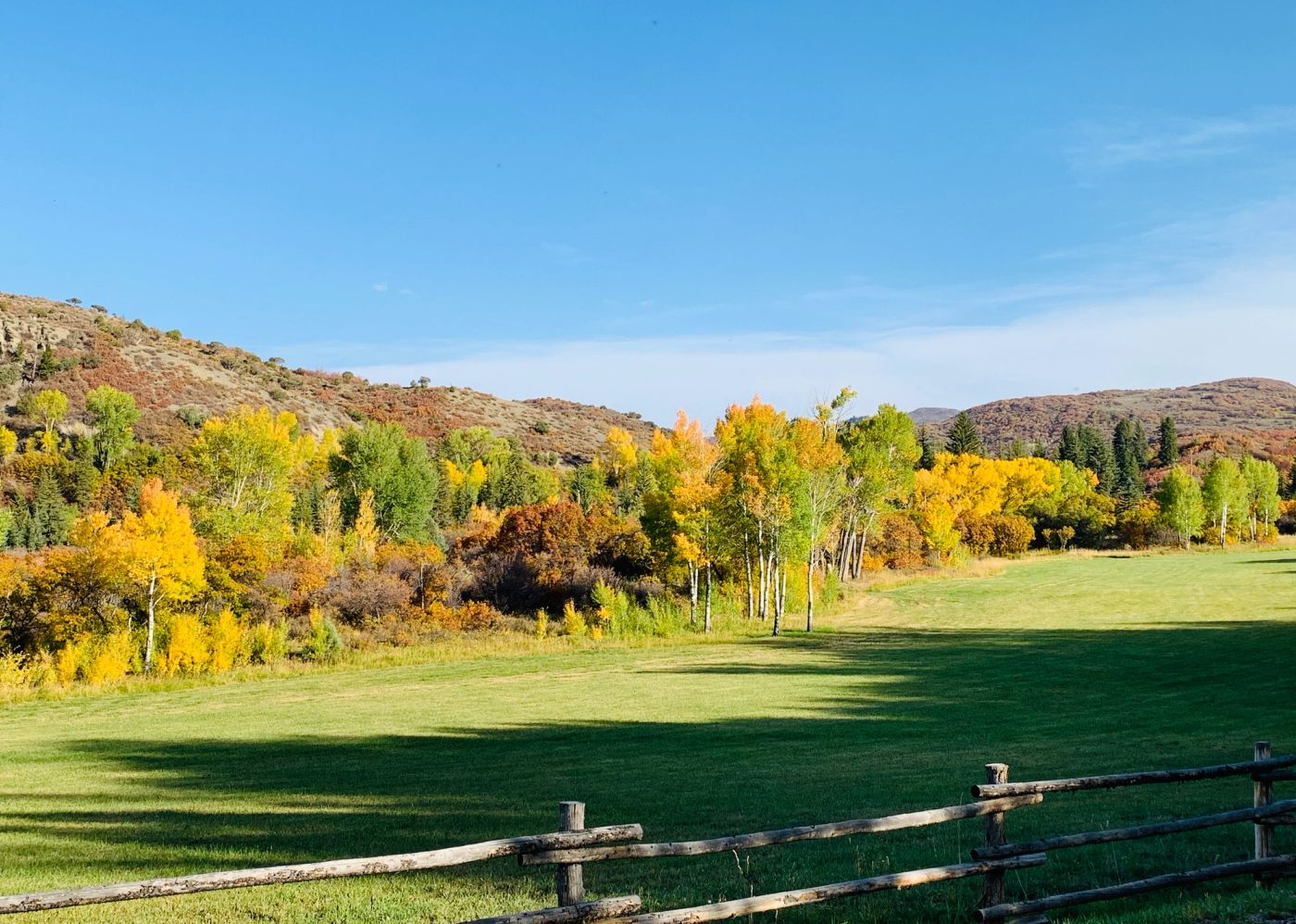 Colorado mountain landscape surrounding a peaceful ranch setting.