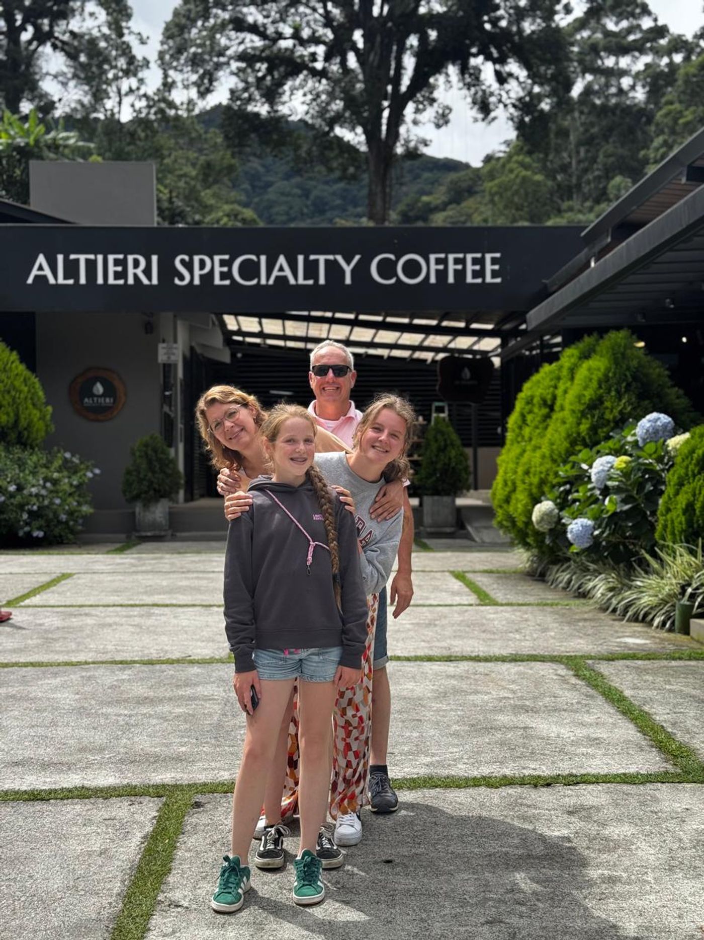 Family learning about Panamanian coffee during a coffee farm experience in the Boquete highlands.