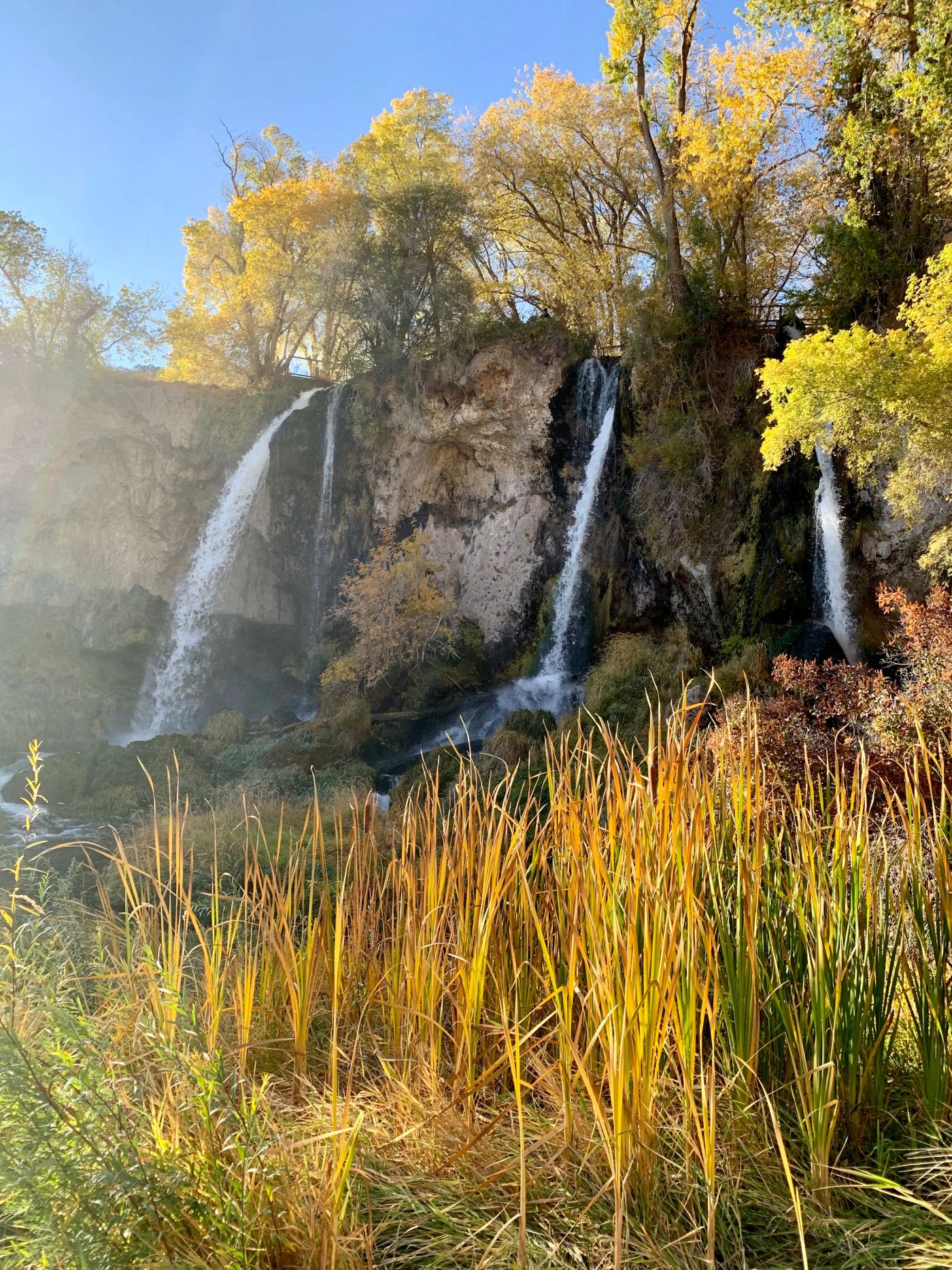 Three waterfalls cascading over the cliffs at Rifle Falls State Park in Colorado.