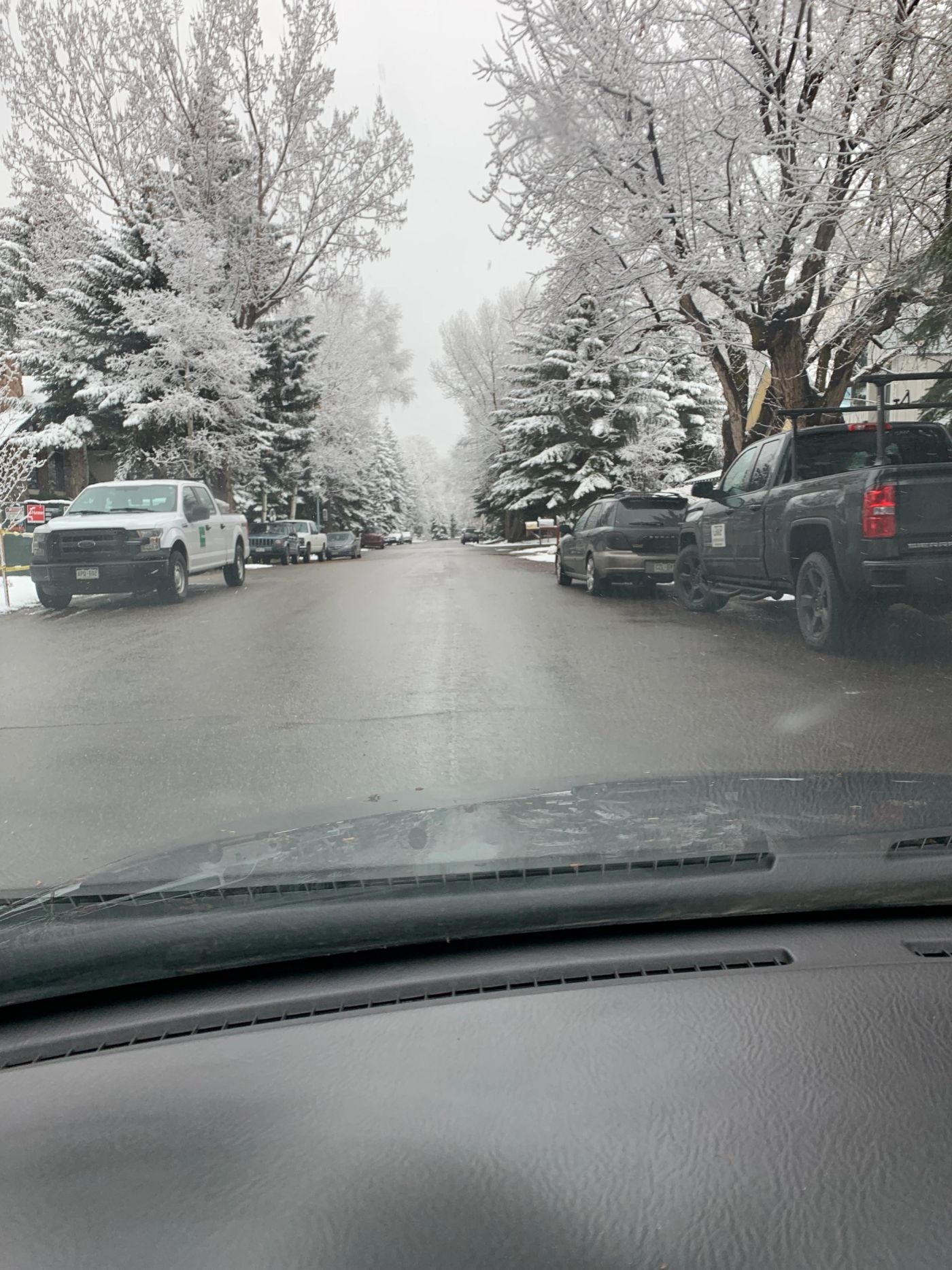 Snow-covered side street in Aspen, Colorado during winter.