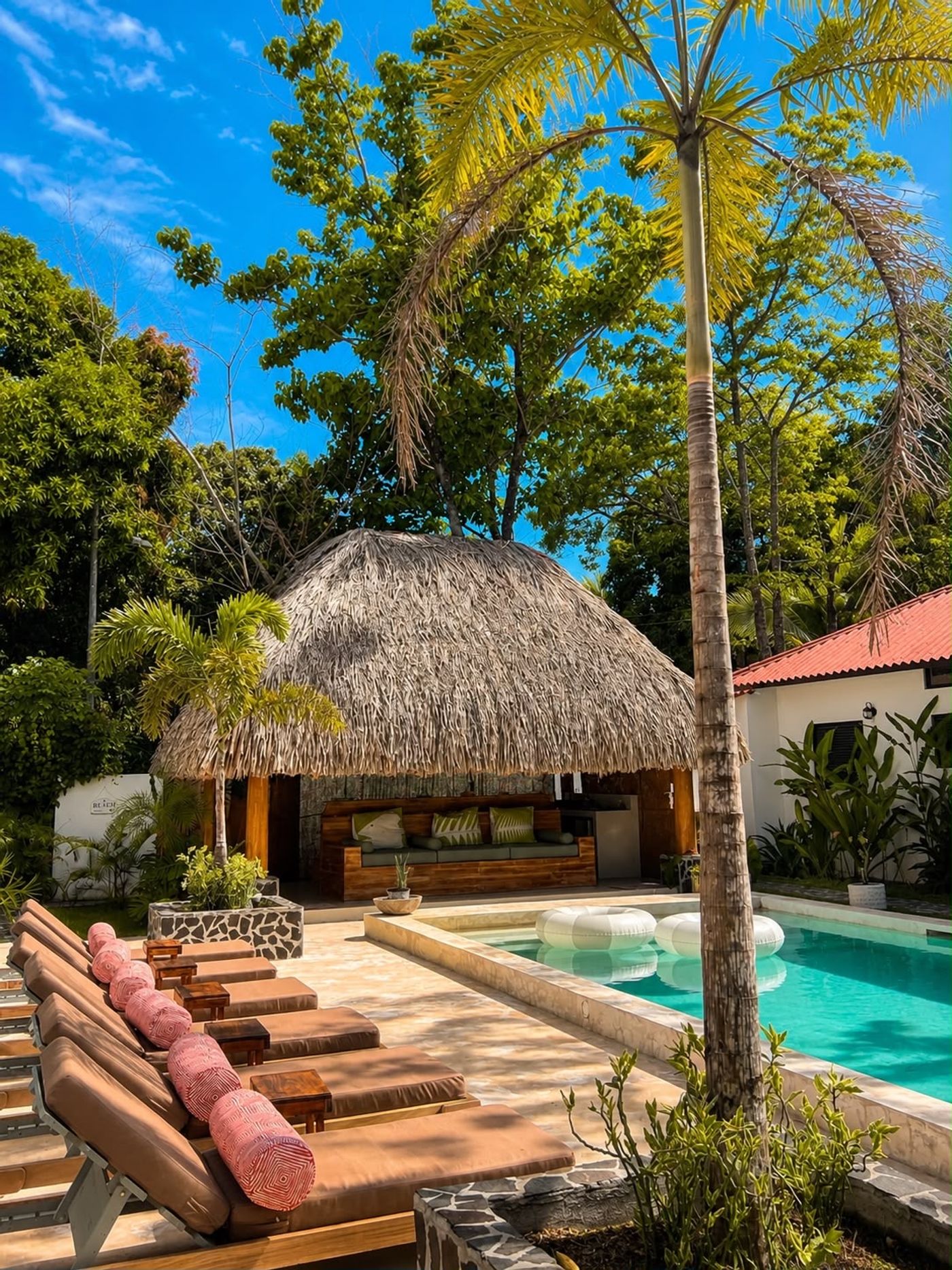 Luxury tropical accommodation in Panama featuring a private pool, modern bedroom and lush surrounding greenery.