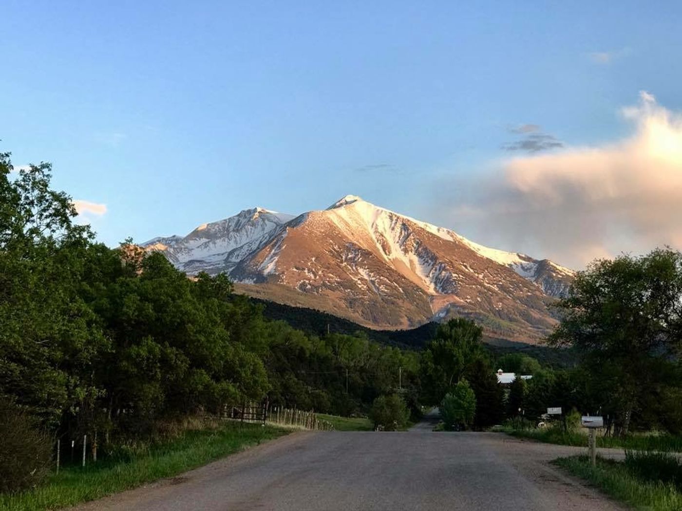 Scenic road through Colorado's Roaring Fork Valley with Mount Sopris in the distance.