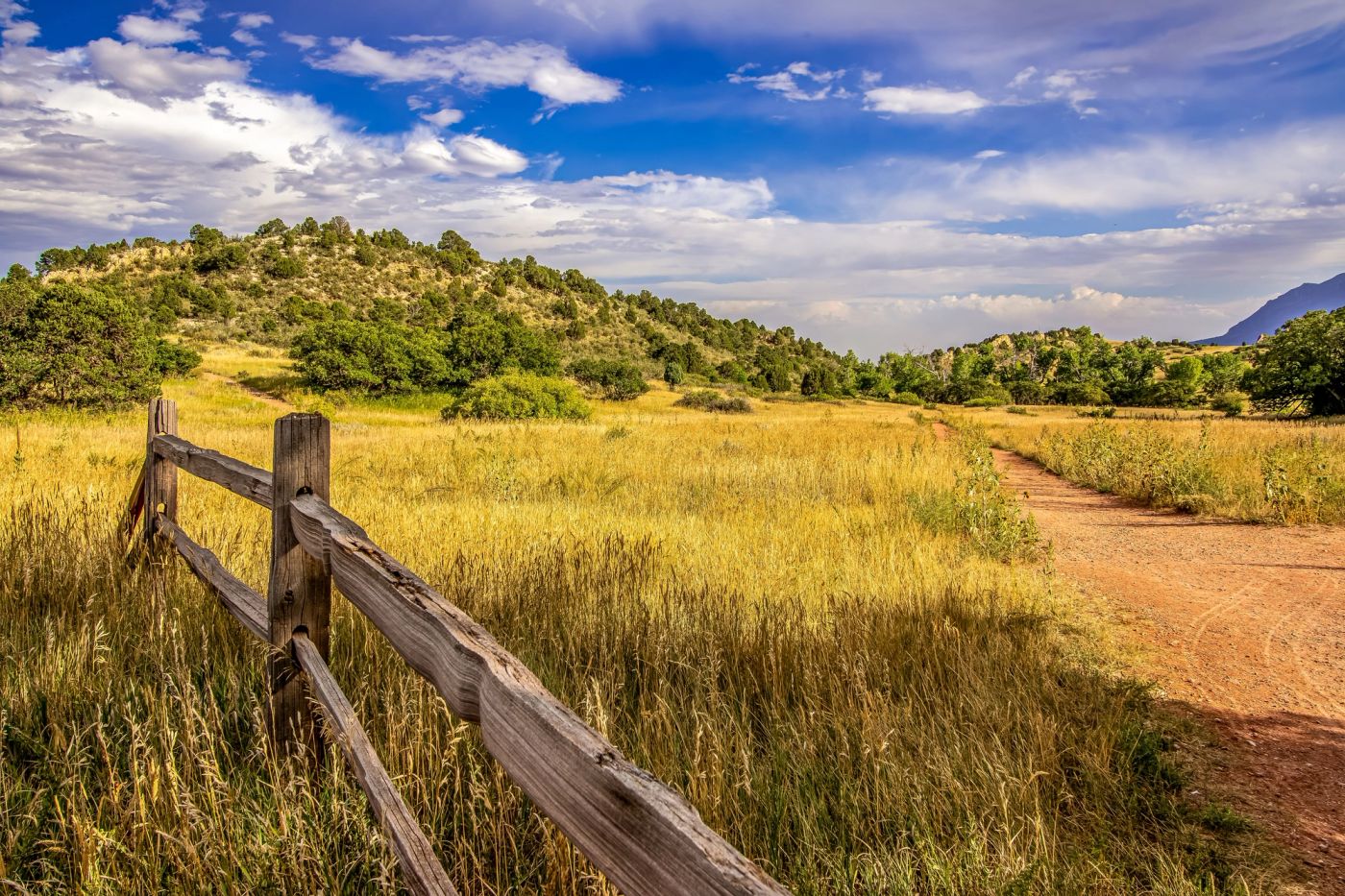 Private ranch landscape surrounded by Colorado mountain scenery.