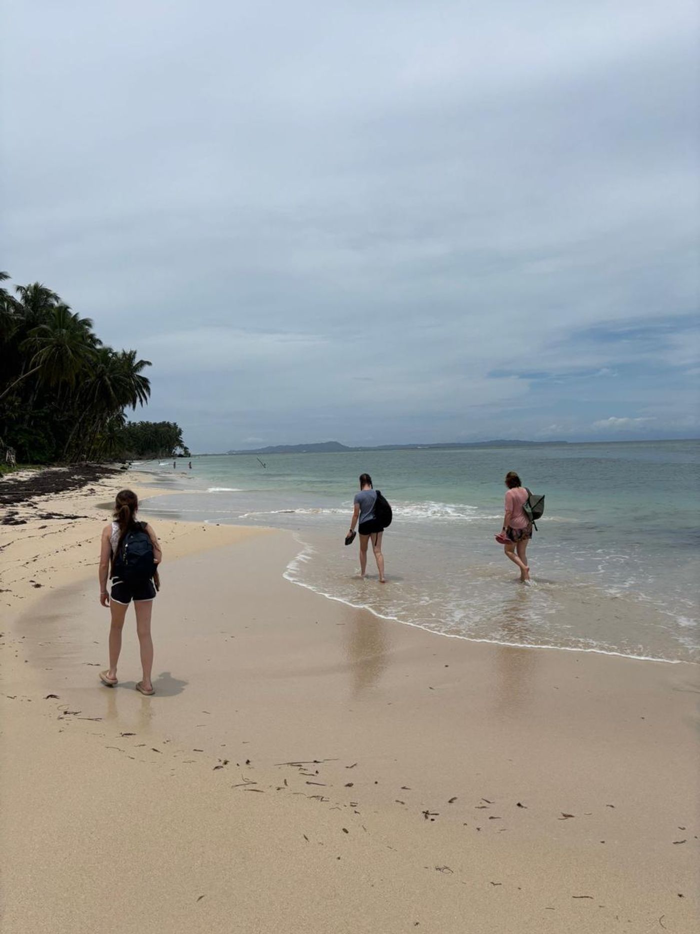 Family relaxing together on a tropical beach during a private Panama vacation.