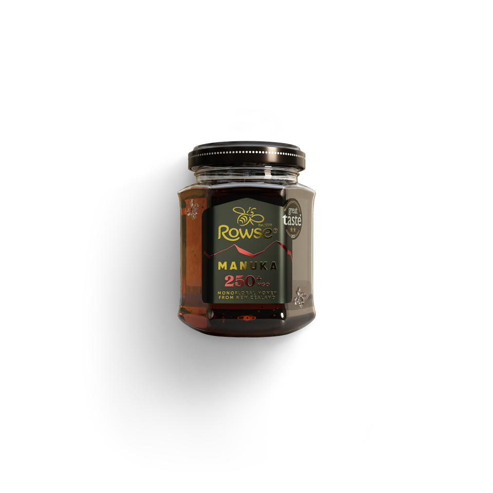 A jar of Rowse Manuka Honey 250 MGO with a black lid and a dark green label.