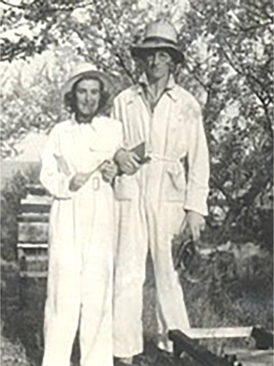 a black and white photo of a man and woman standing next to each other
