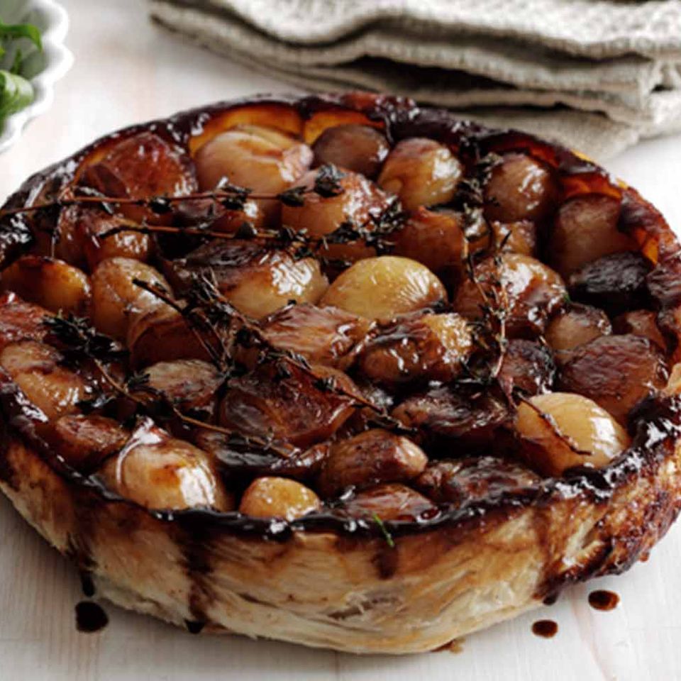 a pie with potatoes on top of it is sitting on a table .
