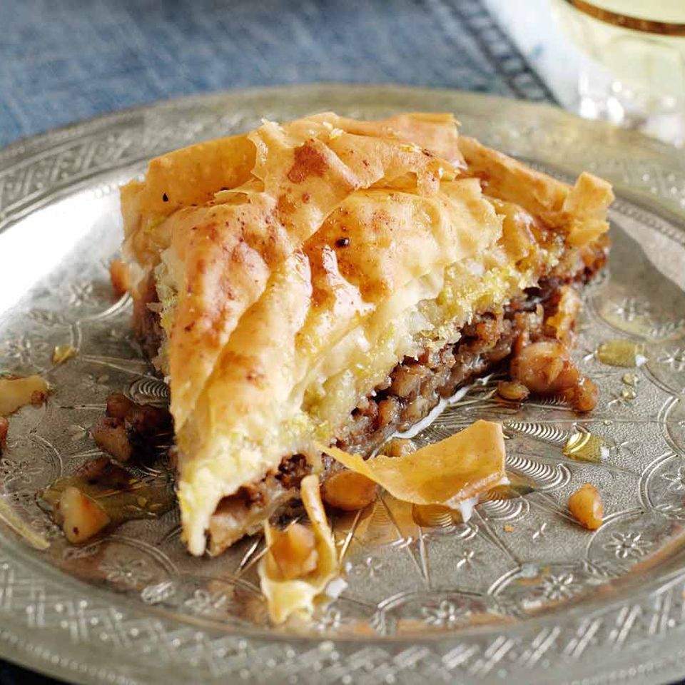 a slice of baklava is on a silver plate .
