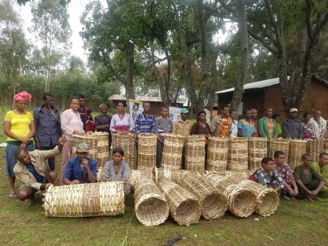 a group of people are posing for a picture with wicker baskets .