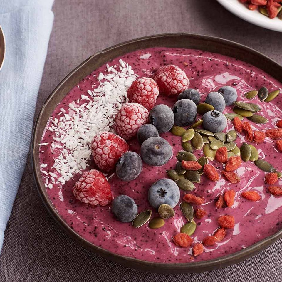 Antioxidant purple smoothie bowl with frozen berries and coconut