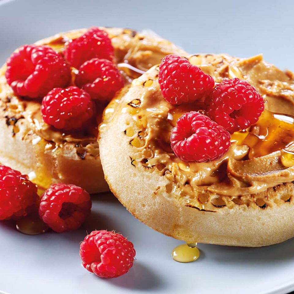 Crumpets with almond butter, raspberries and honey