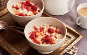 Honey, oat and seed bircher muesli with red berries and yoghurt