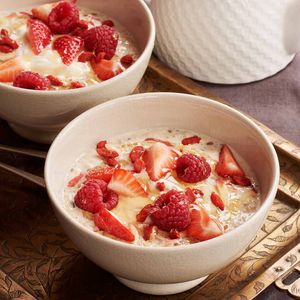 Honey, oat and seed bircher muesli with red berries and yoghurt