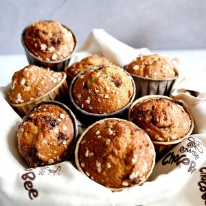a bunch of muffins in a basket on a napkin
