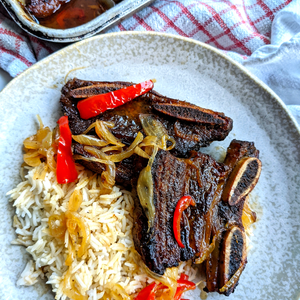 a plate of food with rice and meat on it