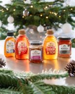 several bottles of rowse honey are on a table in front of a christmas tree