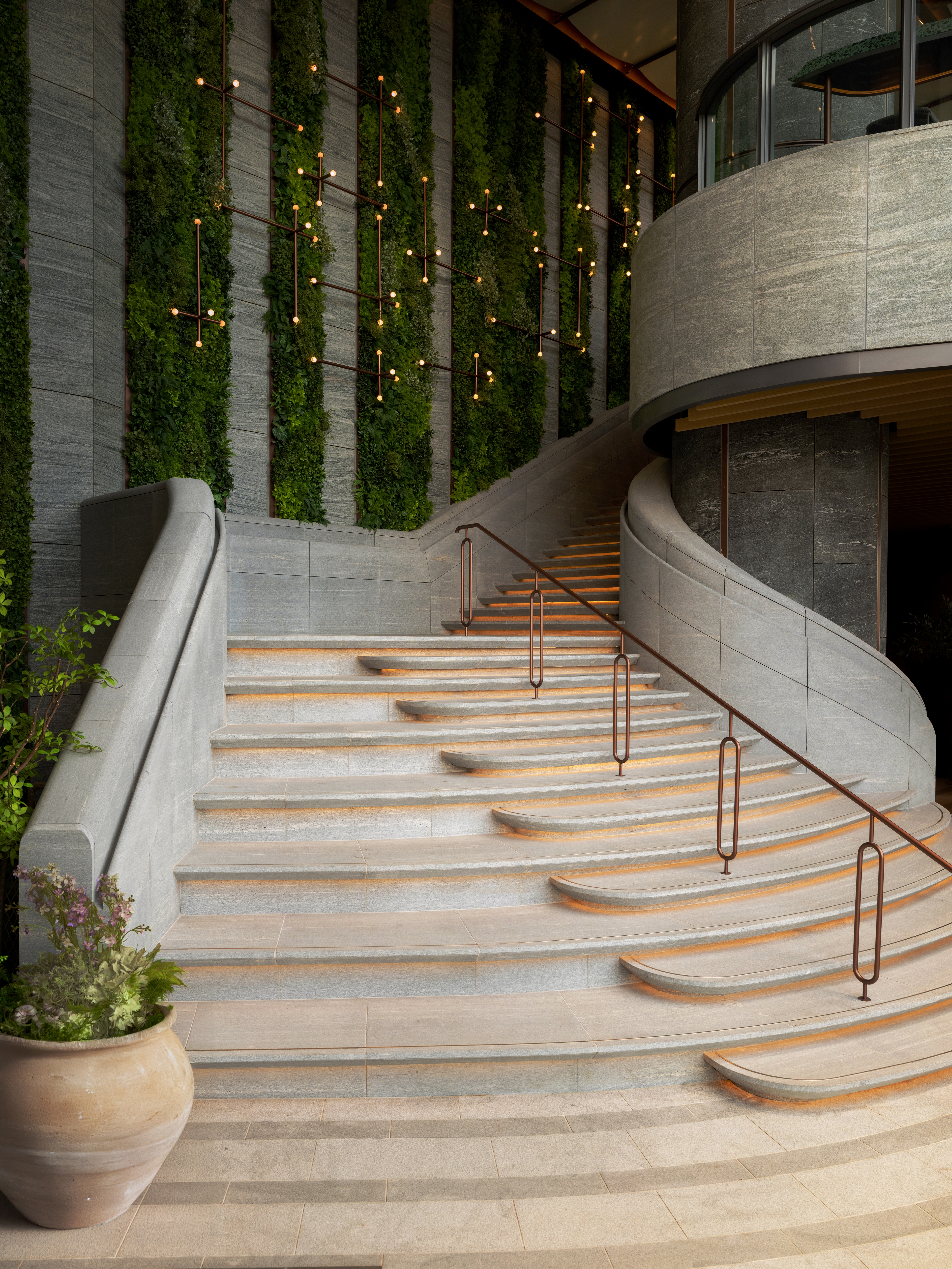 curved stone stair with green wall
