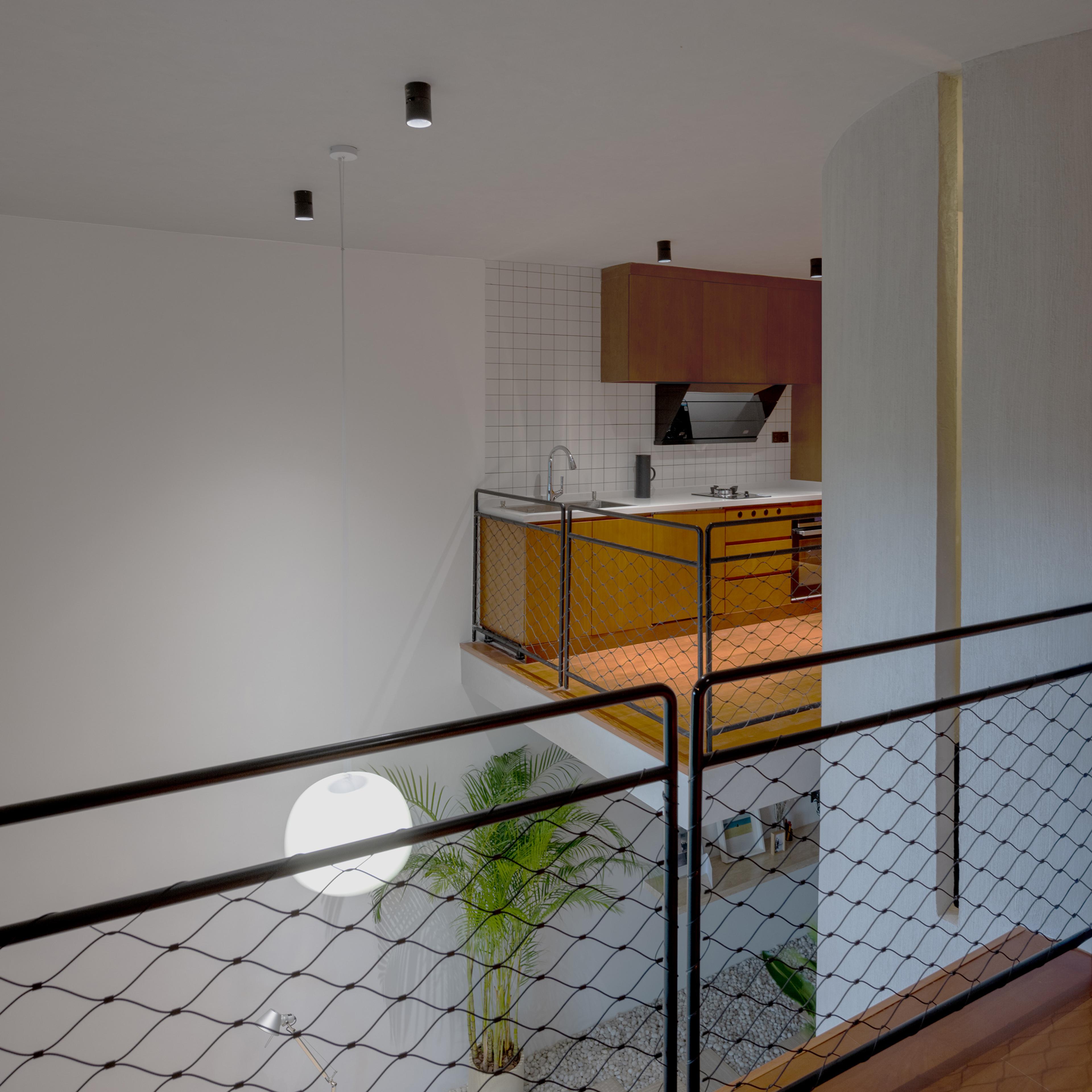interior of loft apartment with kitchen and garden below